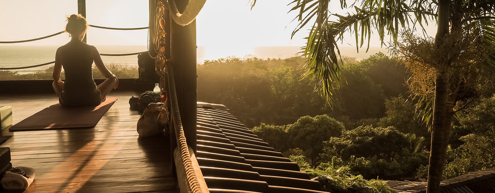 Woman meditating with panoramic jungle views