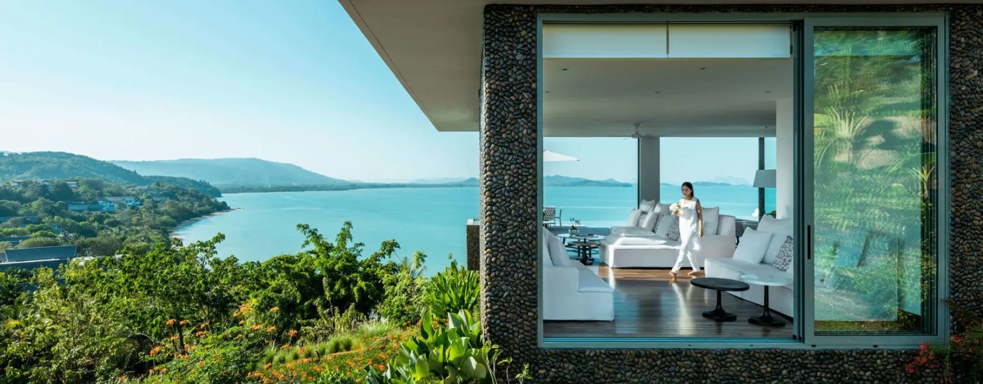 Como Thailand hotel with lush greenery and ocean in the background