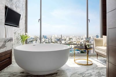 freestanding bath in sukhothai suite with panoramic views over bangkok at 137 pillars bangkok