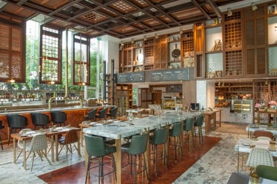 interior view of long tables and bar at the bangkok trading post bistro and bar