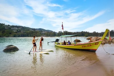 Couple paddle boarding at Anantara Layan, Phuket