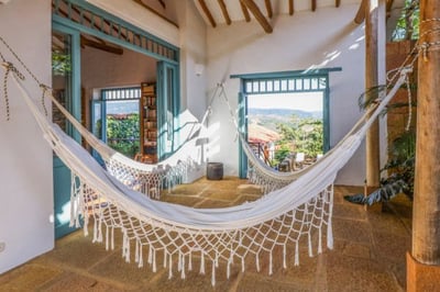 Hammocks hanging on a terrace with mountain views