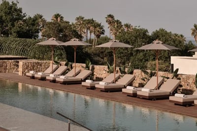 Sunbeds and pool at OKU Andaluisa