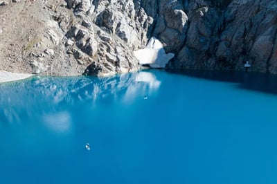 Paddle boarding on a blue lake Rio Palena Lodge Chile