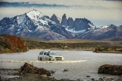car driving through a river in patagonia