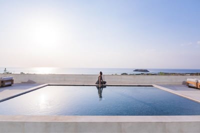 Lady by swimming pool next to the main hotel lobby