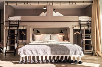 nomad room with double bed and bunkbeds at the cervo mountain resort in zermatt