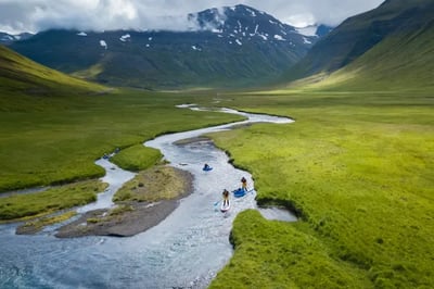 Stand up paddle boarding on a river at Deplar Farm Iceland