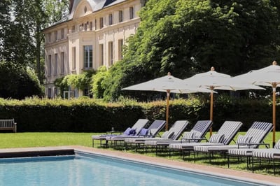 Tranquil poolside setting at Domaine De Primard Hotel Normandy