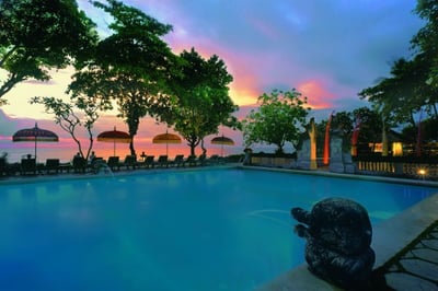 swimming pool overlooking beach and ocean at the oberoi beach resort bali
