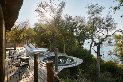 Ourdoor pool overlooking a river at Victoria Falls Luxury Safari Camp