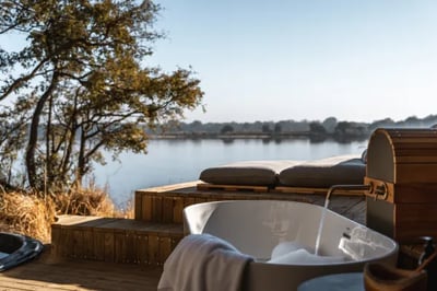 Elegant outdoor bathtub overlooking Victoria Falls Luxury Safari Camp