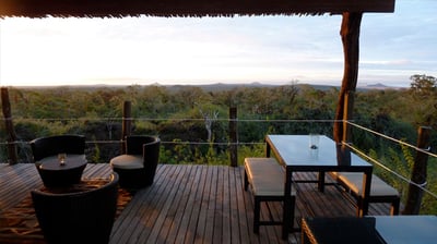 outdoor terrace with tables and chairs with panoramic views at the galapagos safari camp