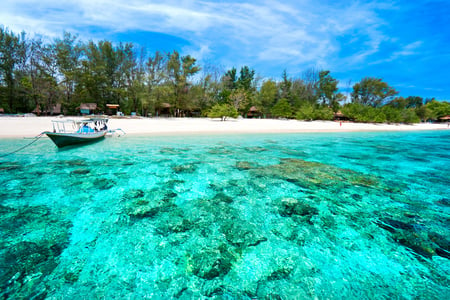 10 Azure beach and clear water of Indian ocean at sunny day. A view of a cliff in Bali Indonesia