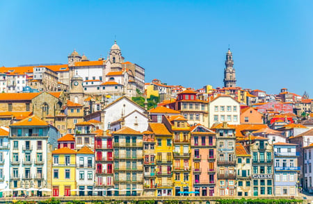 2 Porto, Portugal. Cityscape image of Porto, Portugal with reflection of the city in the Douro River and the Luis I Bridge during sunrise