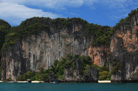 15 Railay beach, natural rock formations and clear blue waters and sampan boat in Krabi Thailand