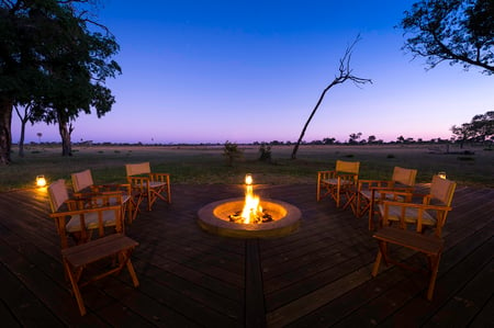 2 safari game vehicle and a lion, Hwange National Park, Zimbabwe