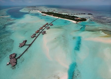 5 Luxury tropical resort or hotel with water villas and beautiful beach scenery. Landscape seascape aerial view over a Maldives