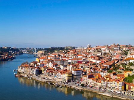 8 Porto, Portugal. Cityscape image of Porto, Portugal with reflection of the city in the Douro River and the Luis I Bridge during sunrise