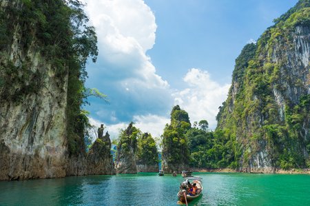 9 Railay beach, natural rock formations and clear blue waters and sampan boat in Krabi Thailand