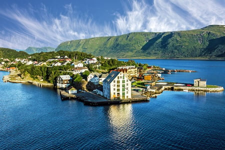 7 Reine, Lofoten, Norway. The village of Reine under a sunny, blue sky, with the typical rorbu houses. View from the top