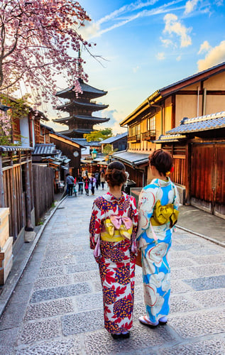 4 Asian woman wearing japanese traditional kimono at Bamboo Forest in Kyoto, Japan.