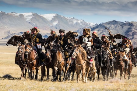 4 Kazakh Eagle Hunter in using trained golden eagles. Olgei,Western Mongolia