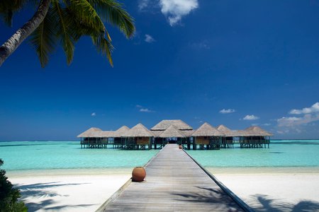 1 Luxury tropical resort or hotel with water villas and beautiful beach scenery. Landscape seascape aerial view over a Maldives