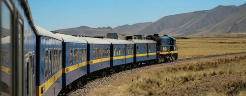 The Belmond train passes through mountainous landscapes in Peru