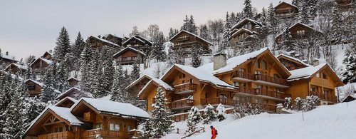 View of cottages and chalets in a ski resort in French Alps, France