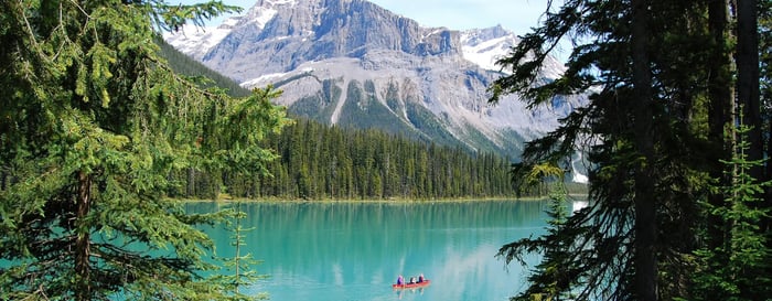  ? People kayaking over crystal clear blue waters in Canada 