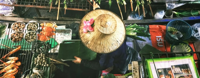 A woman on her boat at a floating market