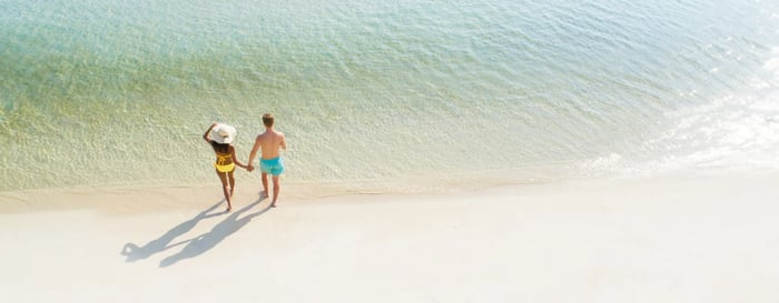Aerial view over a couple on a beach on their honeymoon in Thailand