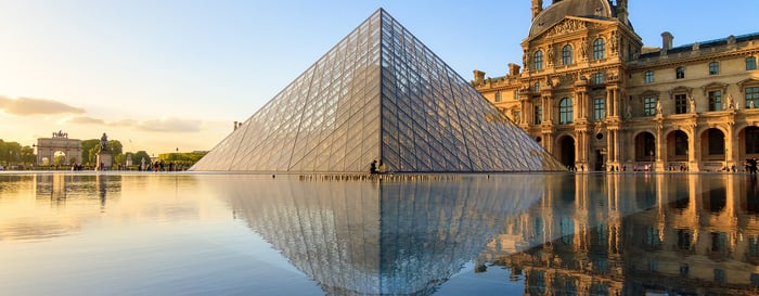 The Louvre museum pyramid at sunset in Paris, France,