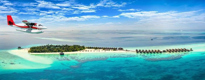Aerial view of a seaplane approaching a tropical island in the Maldives