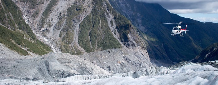 Helicopter flying over Franz Josef Glacier, New Zealand