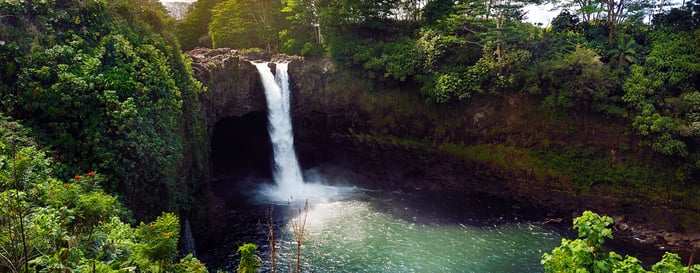 Majesitc Rainbow Falls waterfall in Hilo, Wailuku River State Park, Hawaii. Nnatural lava cave, the mythological home to Hina, an ancient Hawaiian goddess