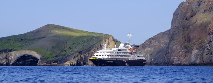 Silversea's luxury expedition cruise ship Silver Galapagos at anchor near one of the stunning Galapagos Islands