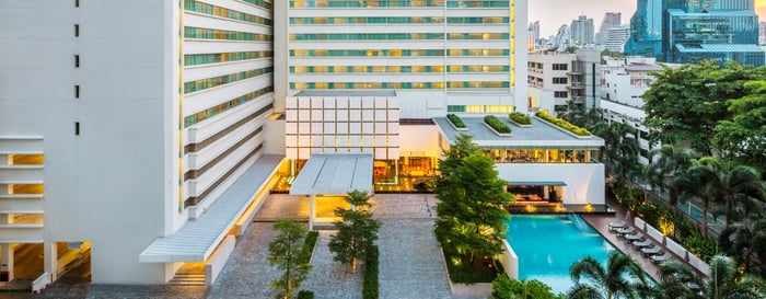 Exterior view of a luxury hotel in bangkok with a pool