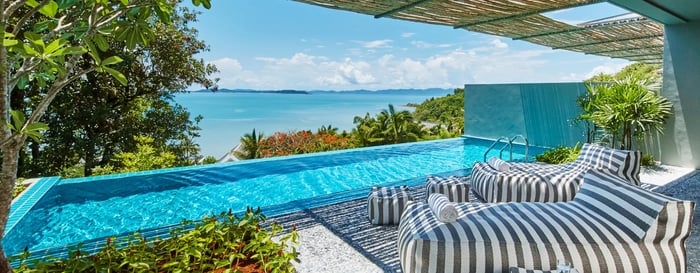 Bean bags next to a private infinity pool overlooking the ocean in Thailand