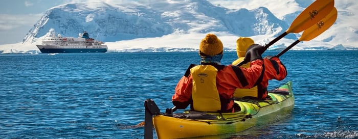 Two people canoeing on a luxury polar expedition