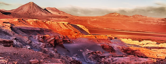 Sunset in front of the volcano and the salt desert