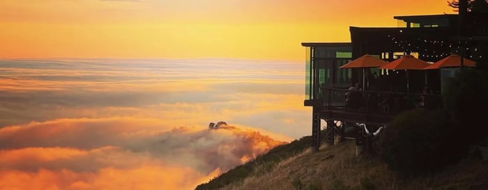 A red sunset with beautiful clouds across Post Ranch Inn California