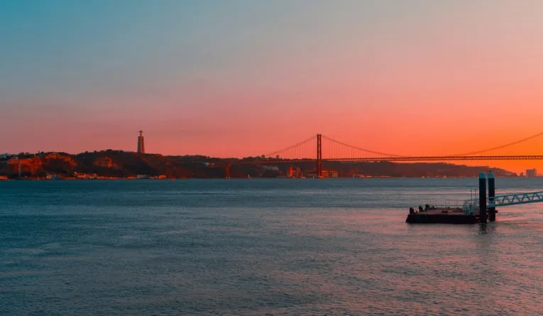 Sunset over the 25 de Abril Bridge and the Tagus River Tagus River in Lisbon, Portugal