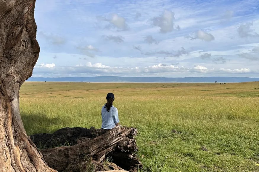 Woman looking across the Masaai Mara