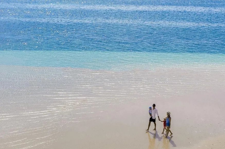 family walking on the beach