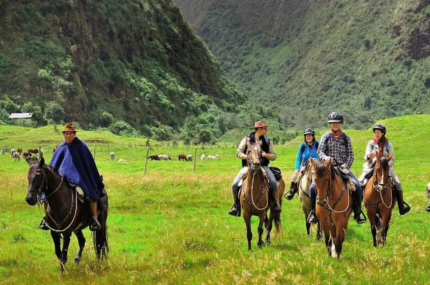 A group of people riding horses in Ecuador