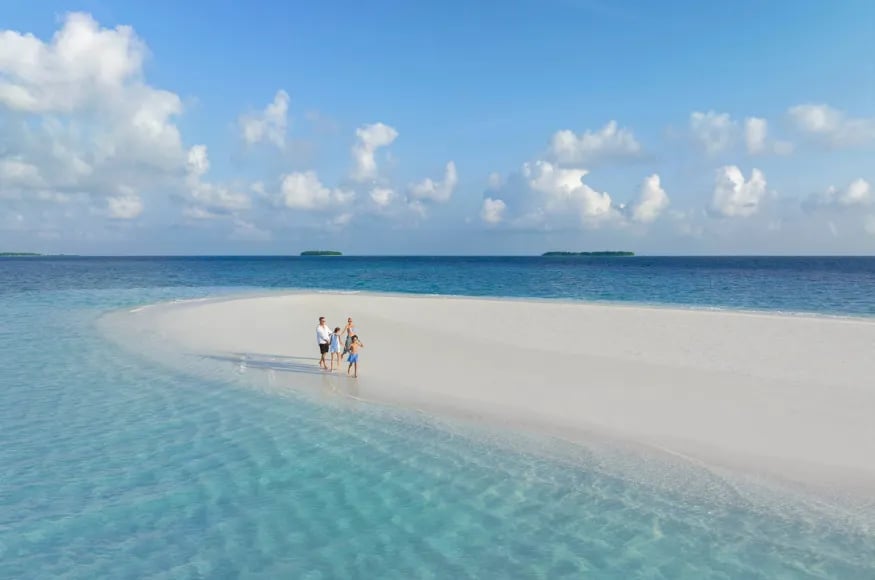 Family walking across a Maldivian beach