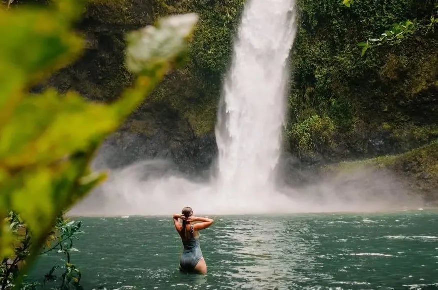 A woman enjoying a waterfall in Australia
