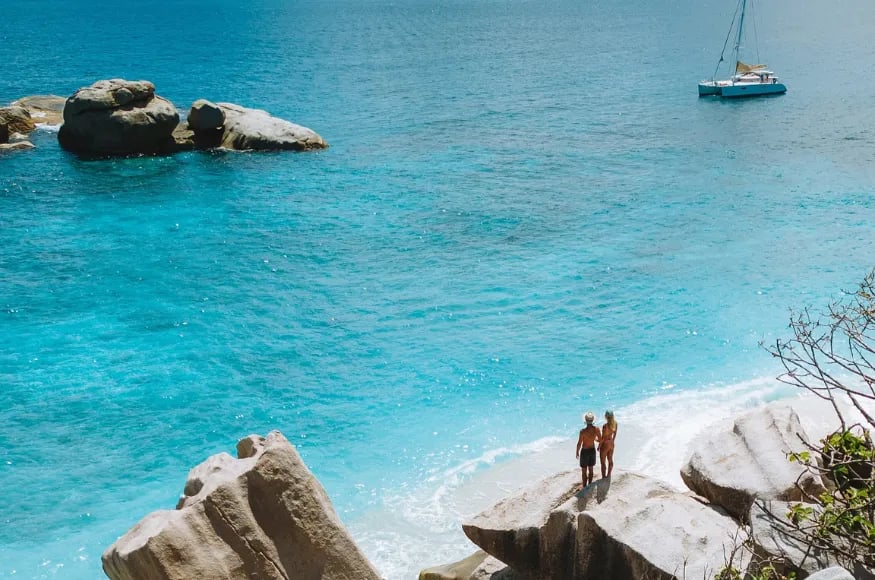 Two people stood on a rock in the Seychelles